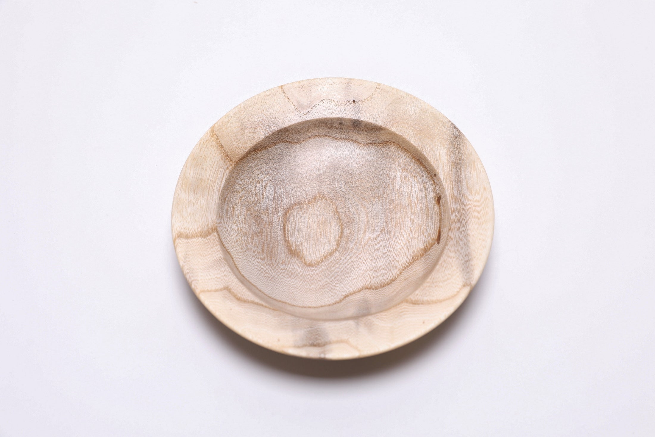 Handcrafted ironwood ring dish, angled view highlighting amber growth ring lines