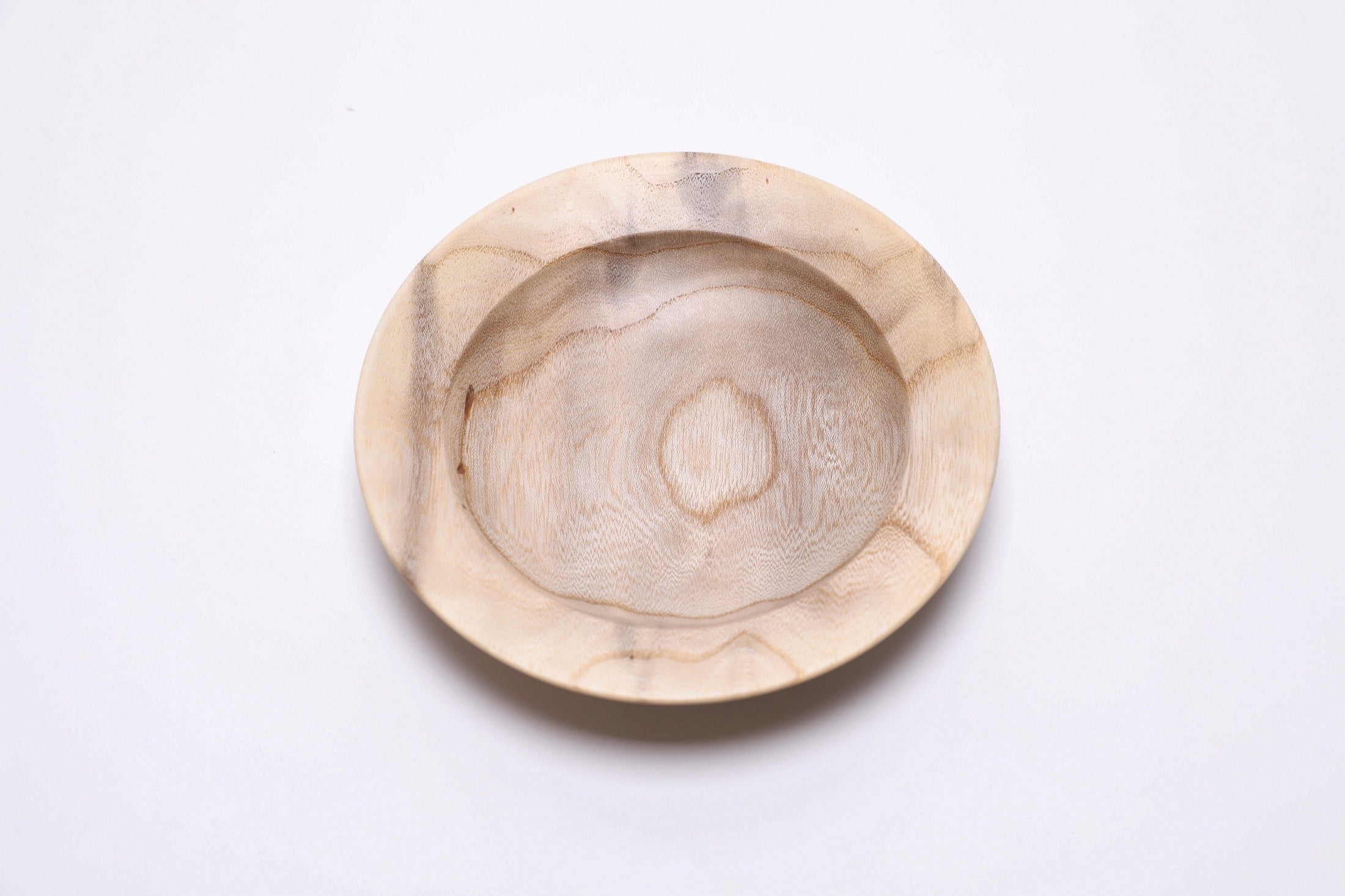 Small ironwood ring dish with food-safe oil finish, close-up of iridescent figure
