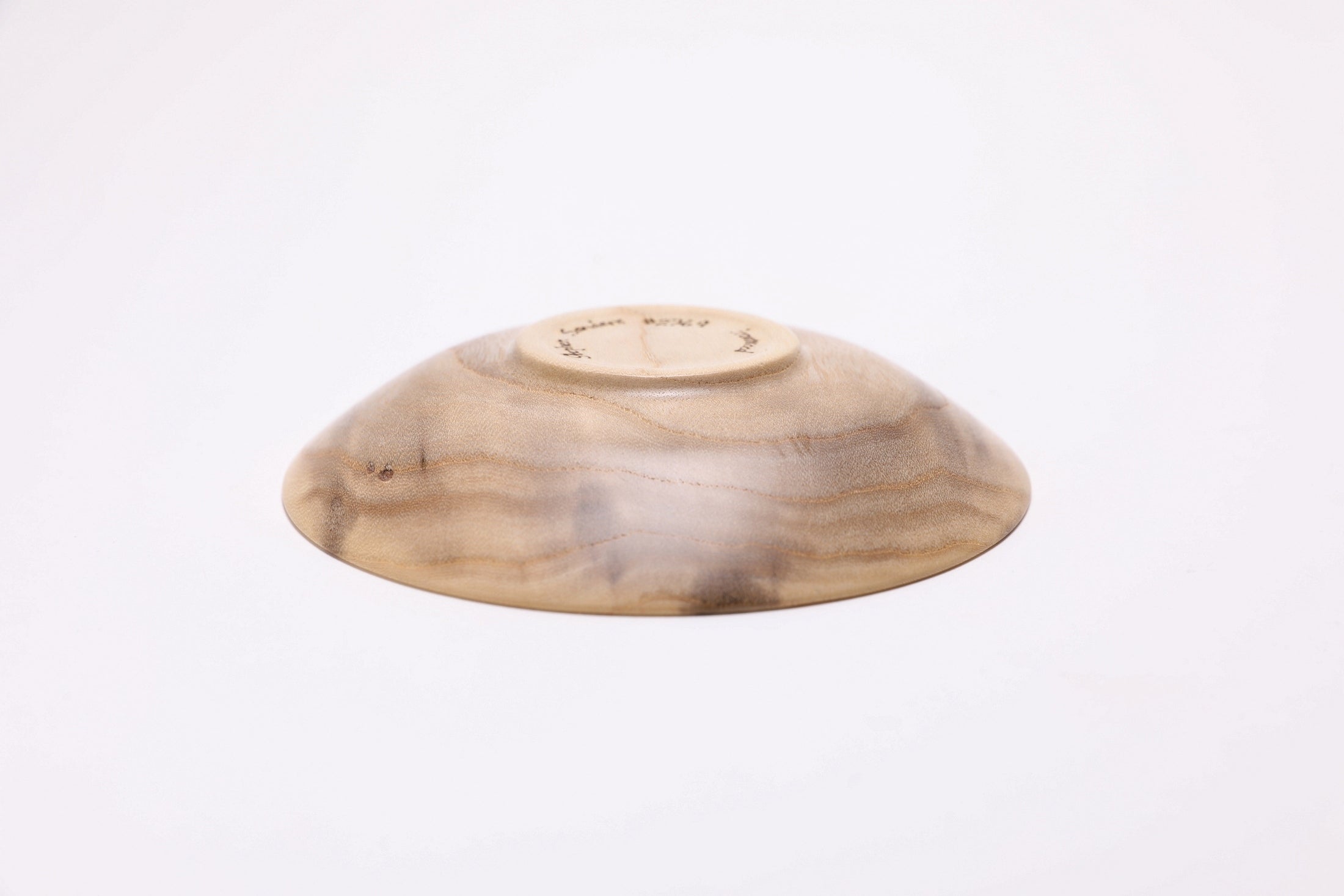 Bottom view Small ironwood ring dish with food-safe oil finish, close-up of iridescent figure