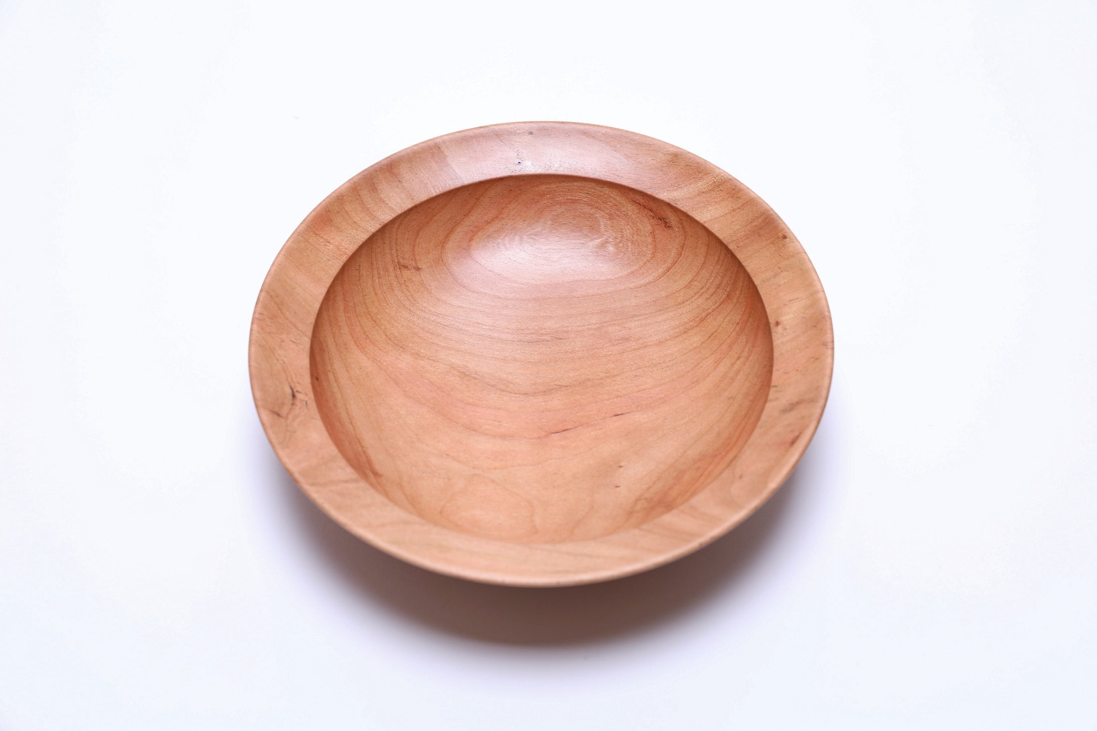 Wild black cherry wooden bowl, top view showing wavy amber growth rings