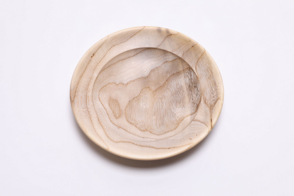 Handcrafted hackberry wood ring dish with iridescent cream-colored wood and natural beetle holes