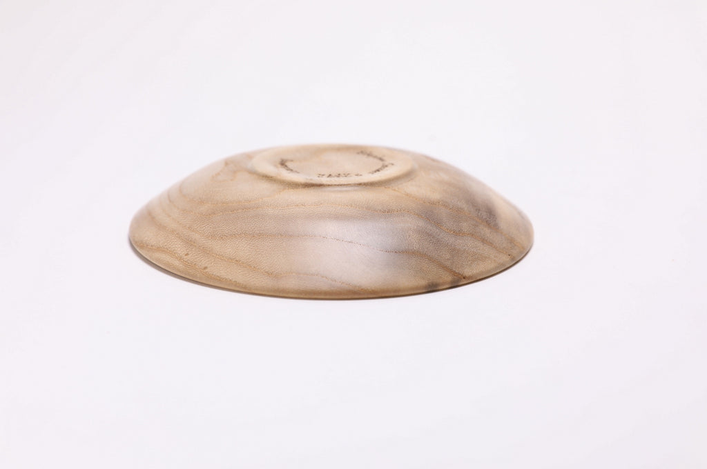 Bottom view  of hackberry wooden ring dish showing iridescent wood surface and natural character 