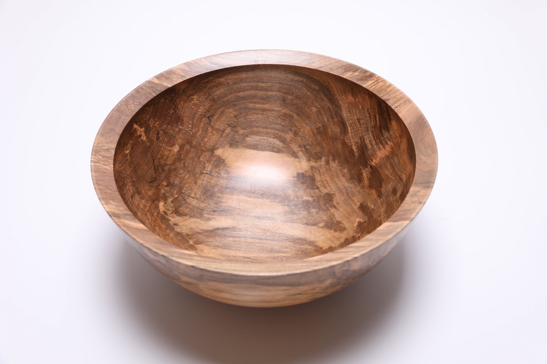 Interior of spalted maple fruit bowl showing cream, salmon, and amber color variation