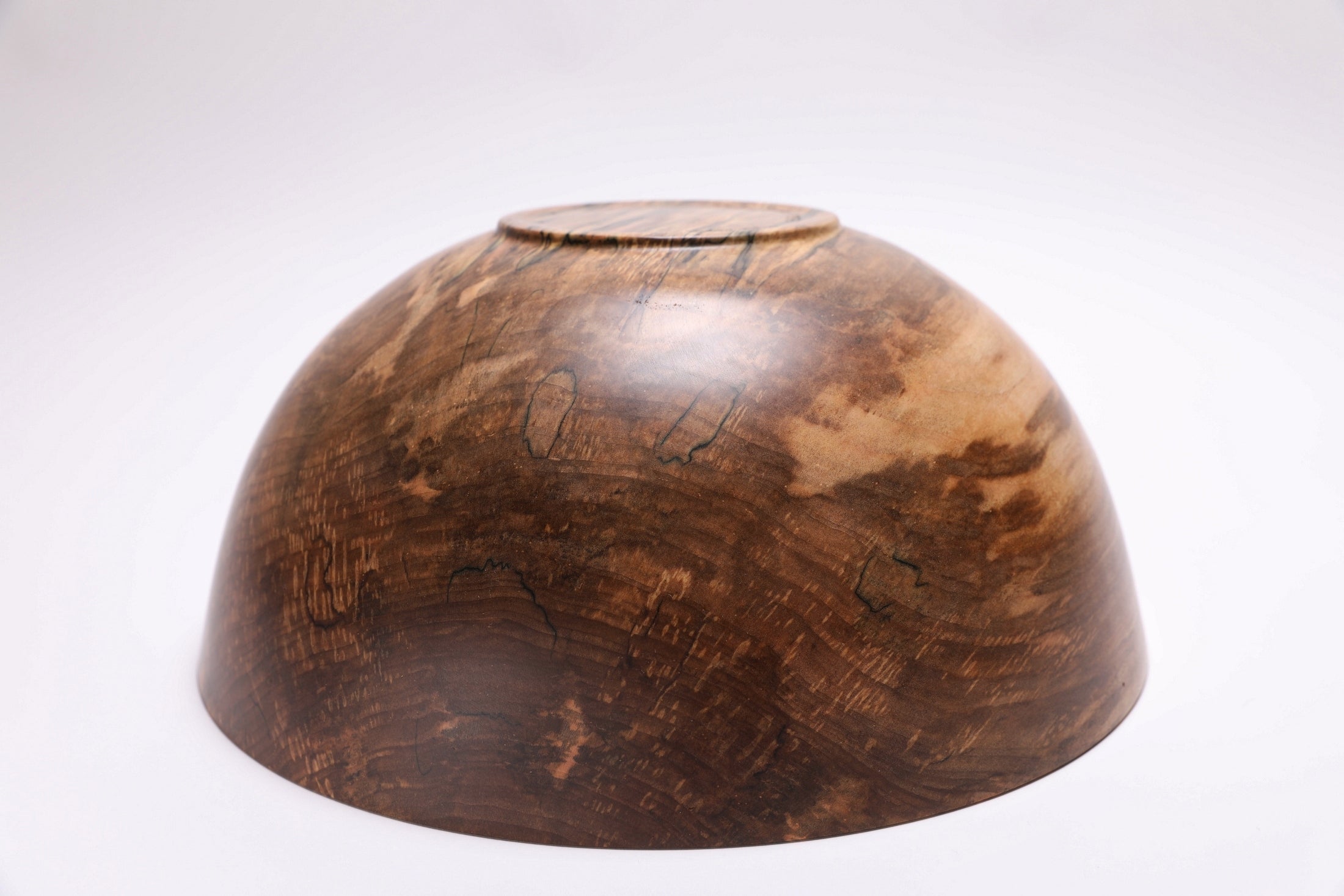 Spalted maple bowl bottom view showing raised foot and natural wood grain — Sanders Woodworking
