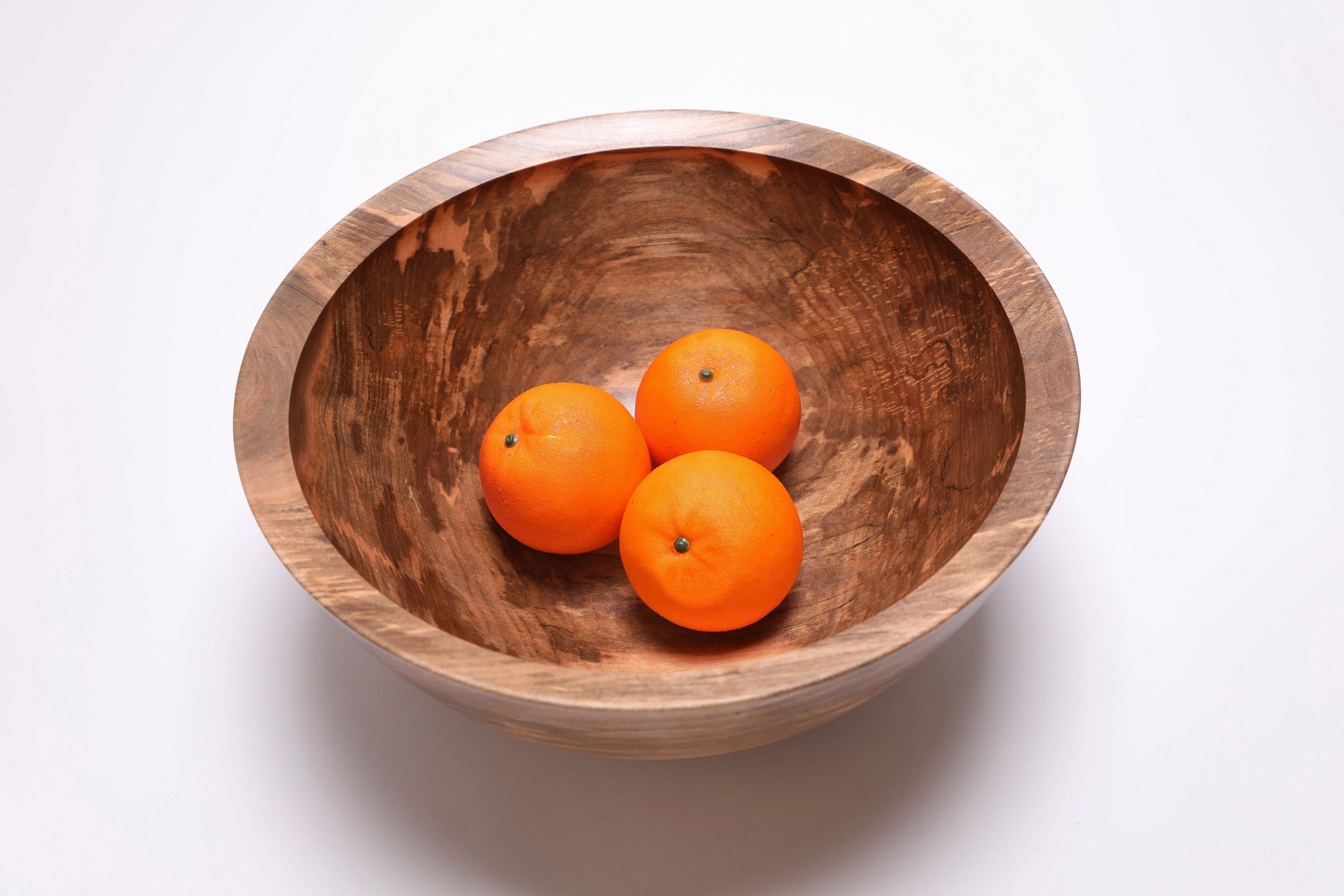 Spalted sugar maple fruit bowl with three oranges, gray and amber tones, handcrafted by Sanders Woodworking