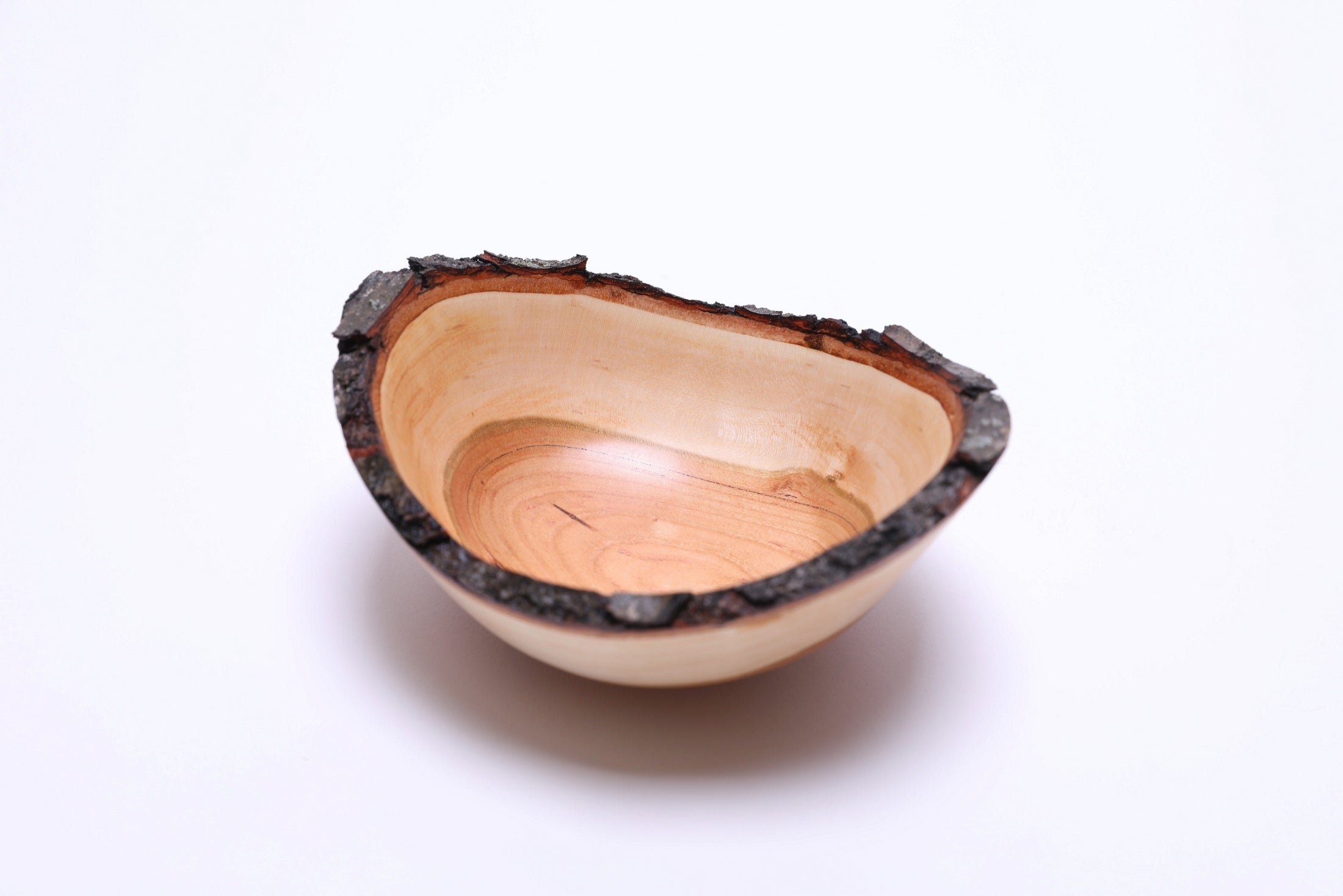 Natural edge black cherry bowl, softball-sized, neutral background