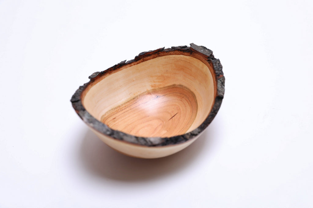 Wild black cherry wooden bowl with natural bark rim, top view