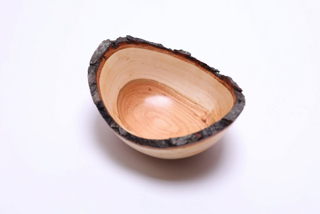 Close-up of copper heartwood and sapwood grain in handmade cherry bowl