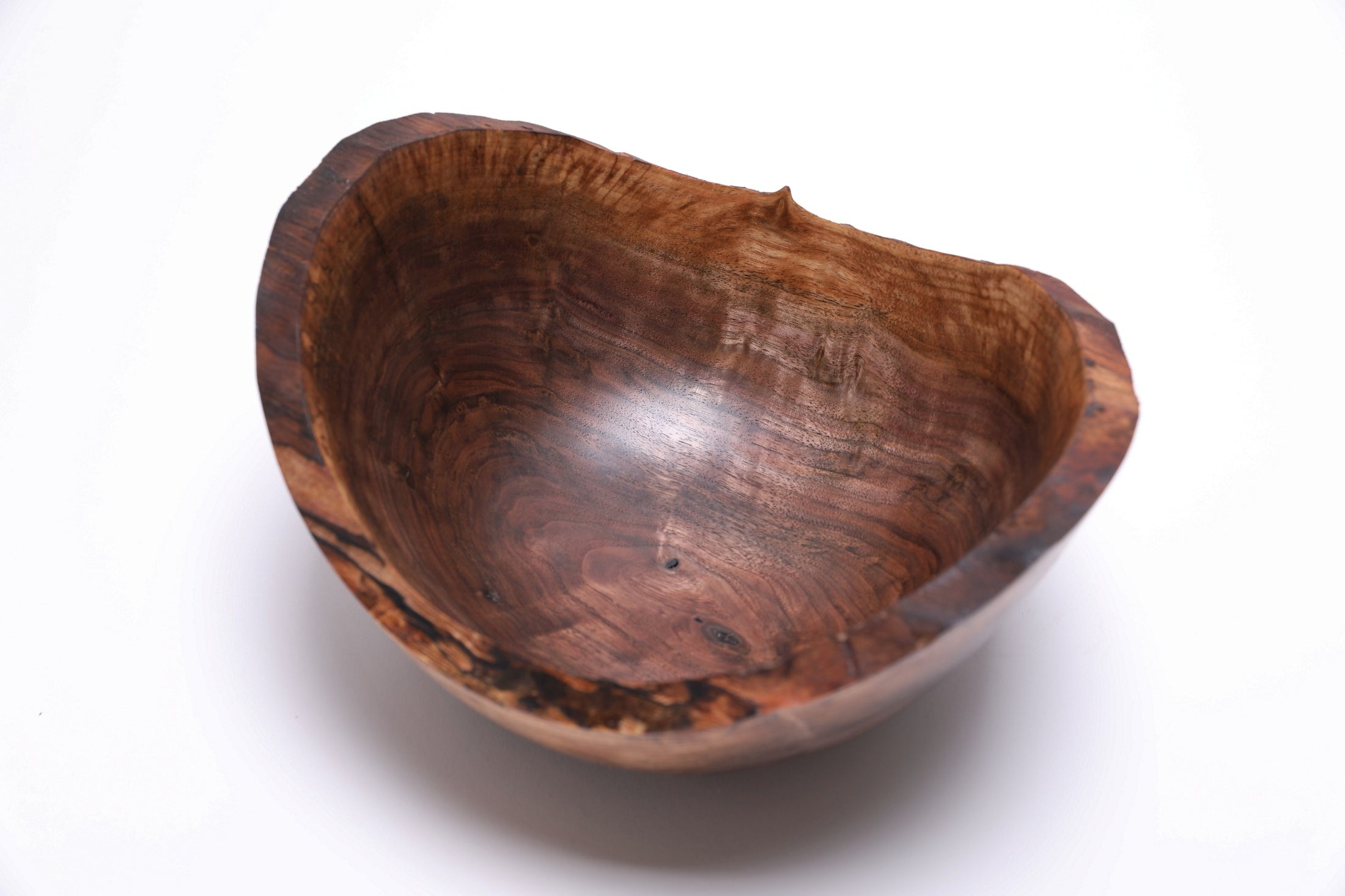 Handmade black walnut bowl — angled view showing bud scars and repaired stress cracks