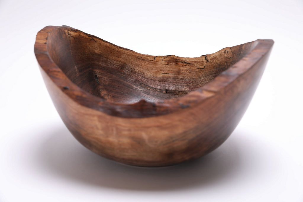Handcrafted walnut burl bowl — lifestyle or scale reference shot
