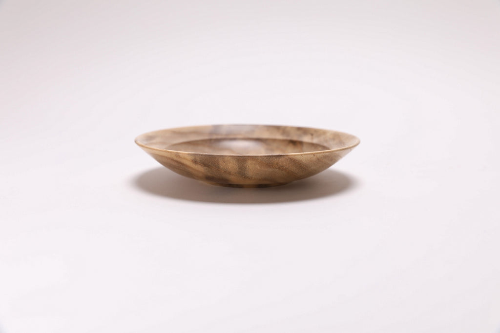 Handmade hackberry wood dish — side  view showing cream, gray, and amber grain tones