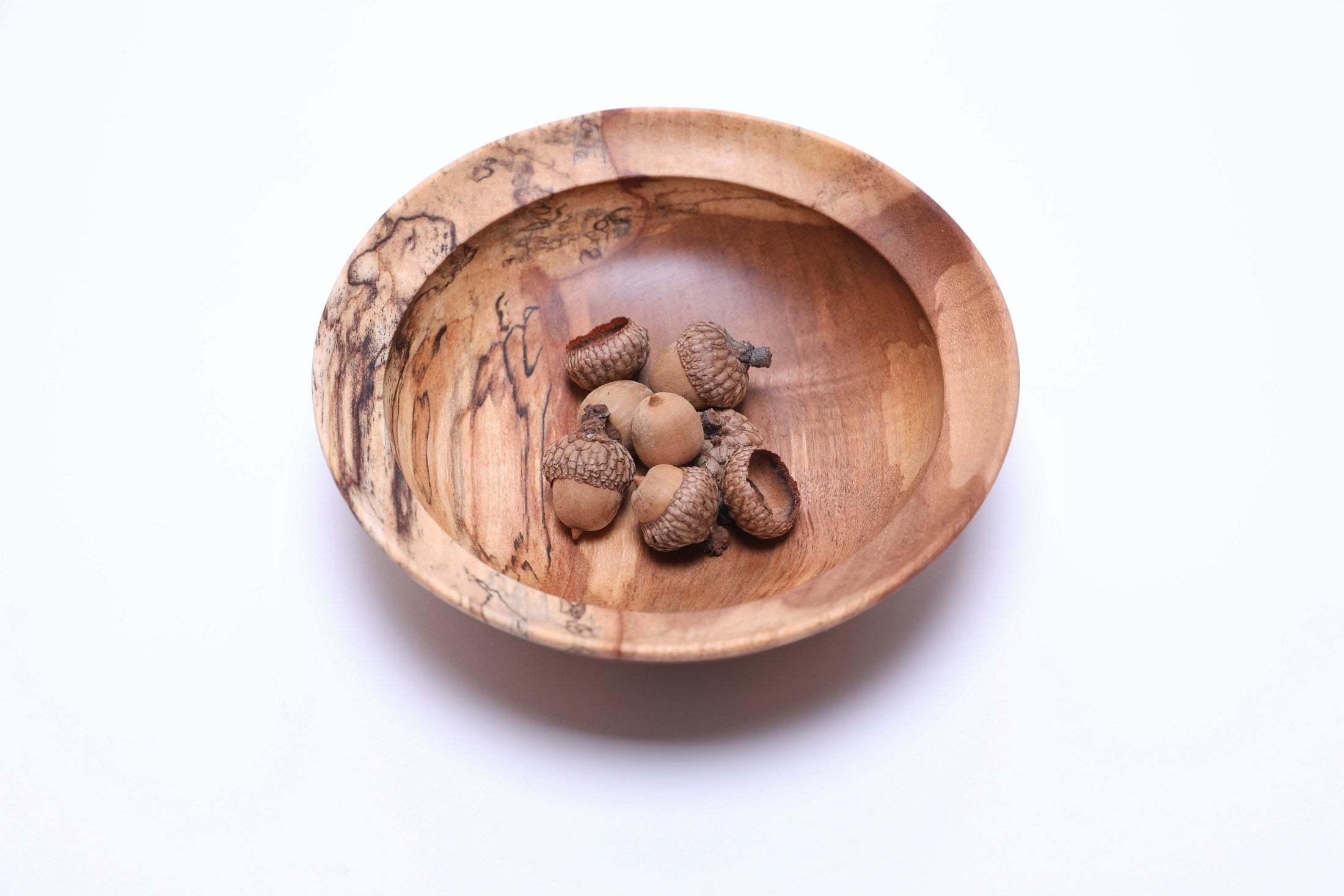 Spalted river birch wooden bowl, top view with acorns for scale, 6⅜" handcrafted bowl by Sanders Woodworking, made in NC