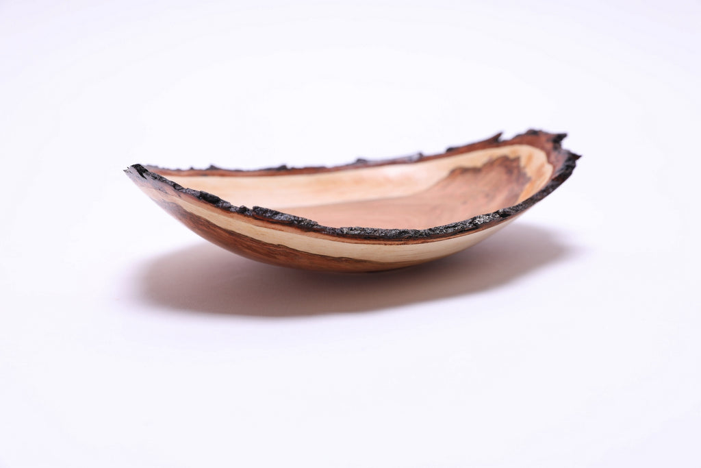 Natural edge wild black cherry wooden bowl, side view showing natural bark rim and sapwood band, handcrafted by Sanders Woodworking