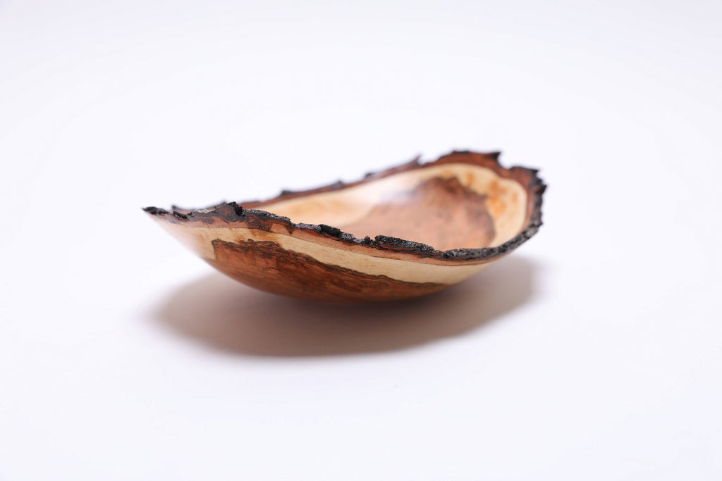 Natural edge wild black cherry bowl, side view at 90°, bark rim and figured heartwood detail, made in NC