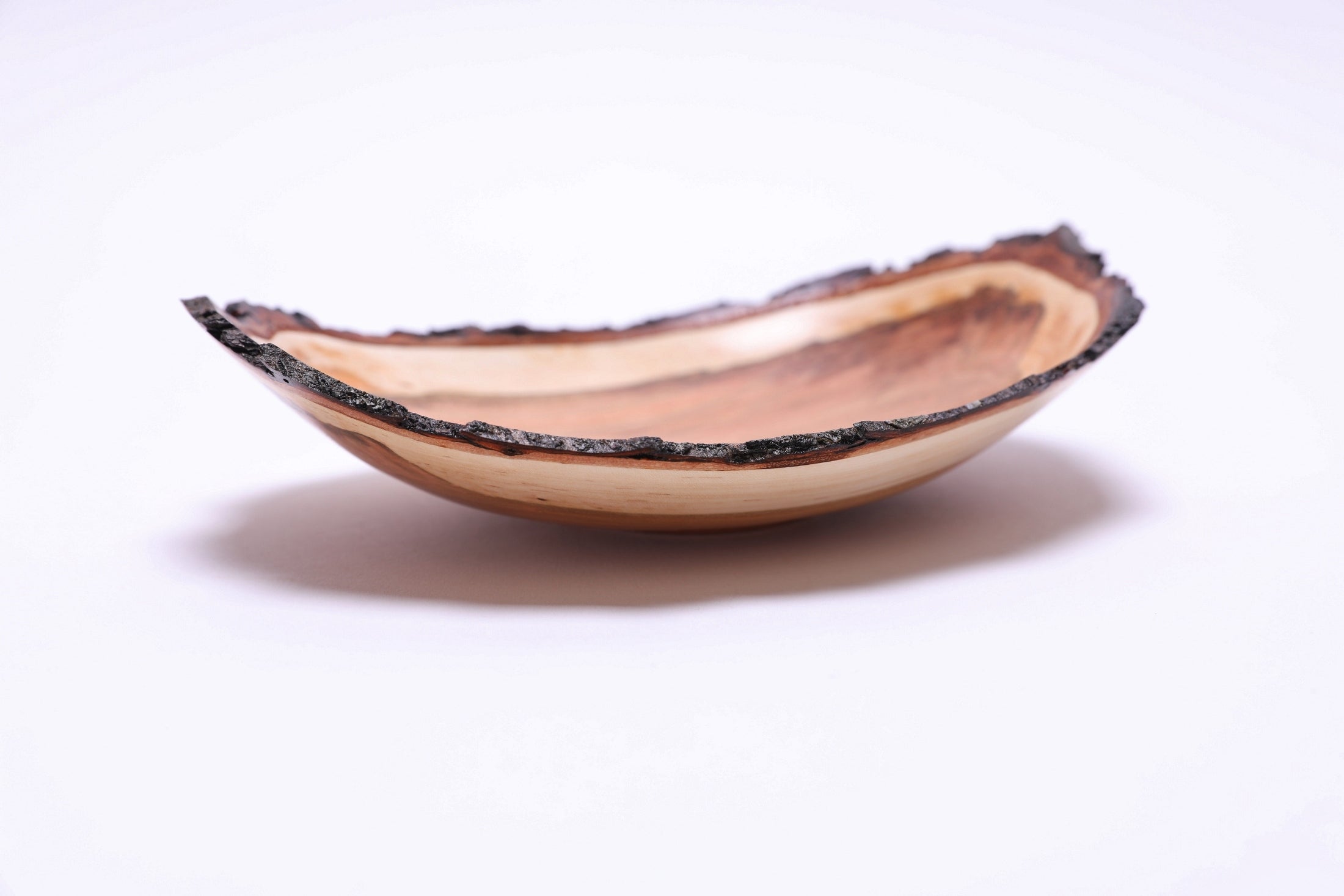 Natural edge wild black cherry bowl, side view at 270°, natural bark rim and food-safe oil finish, handmade in USA