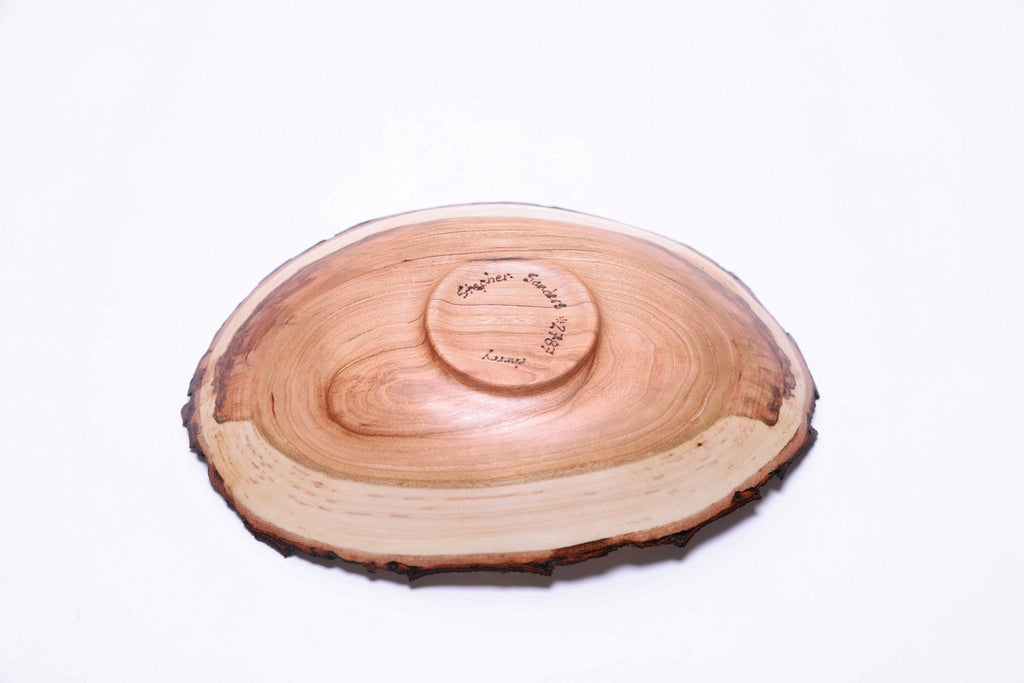 Natural edge wild black cherry wooden bowl, bottom view showing raised foot and maker's signature, Sanders Woodworking