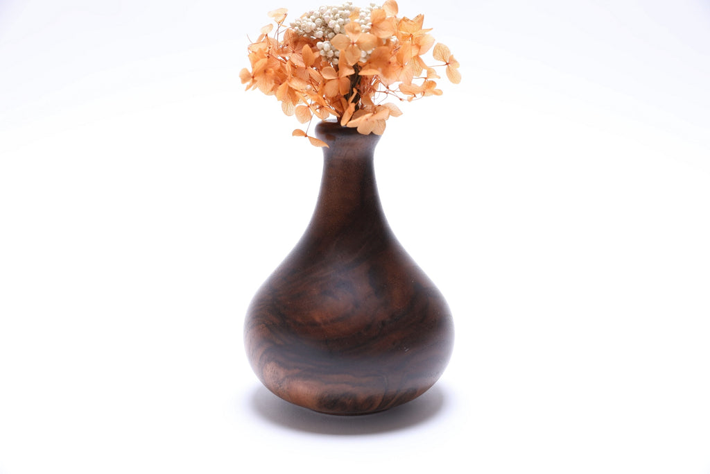 Claro walnut burl weed pot with dried flowers, side view rotated 90 degrees, natural wood grain detail