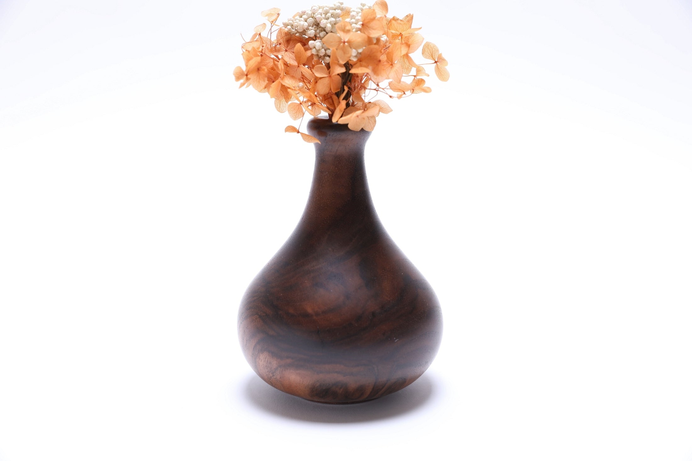 Claro walnut burl weed pot with dried flowers, side view rotated 90 degrees, natural wood grain detail