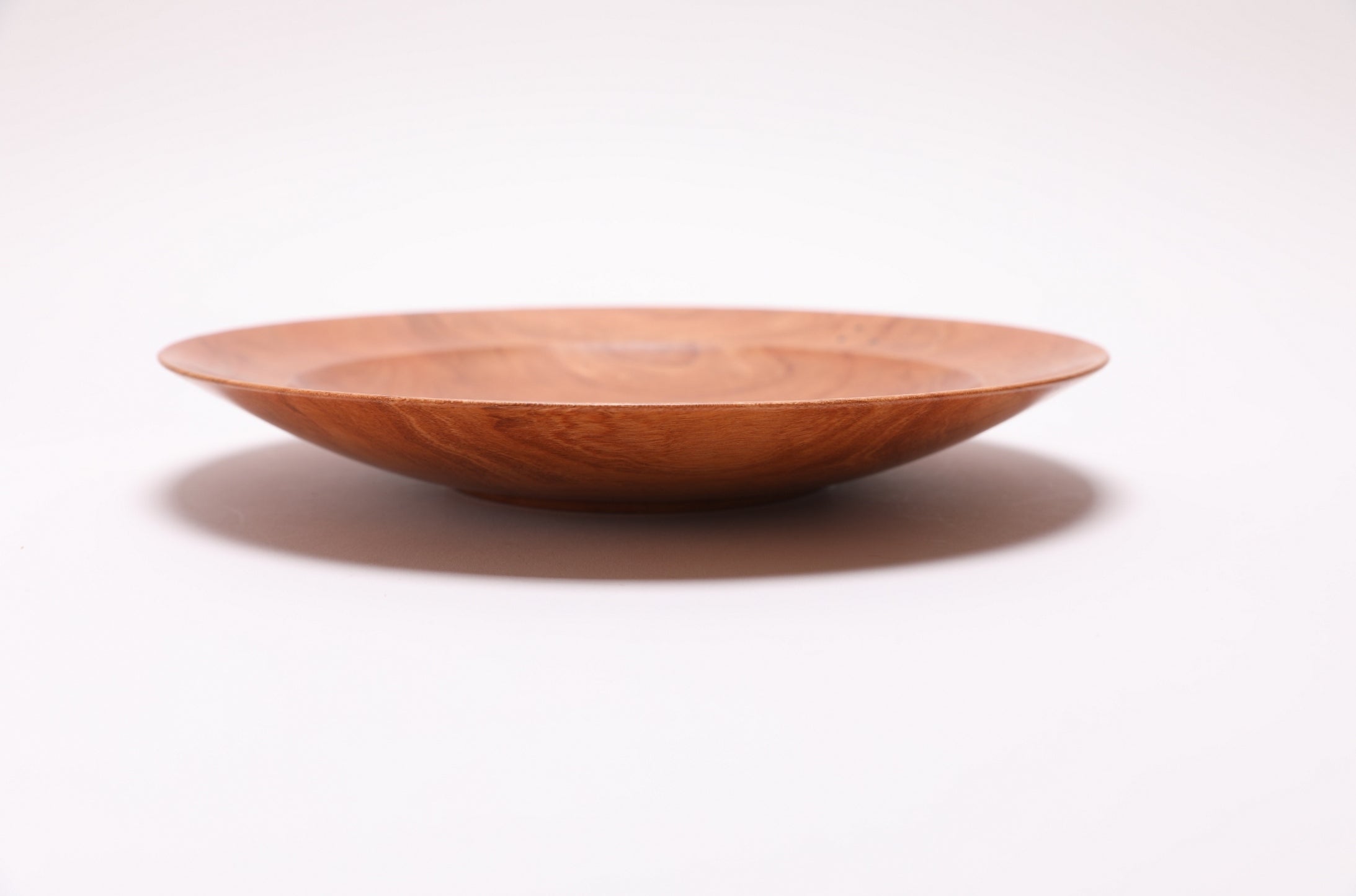 Hand-turned wild black cherry bowl, side view rotated 90 degrees, worm hole detail and food-safe oil finish