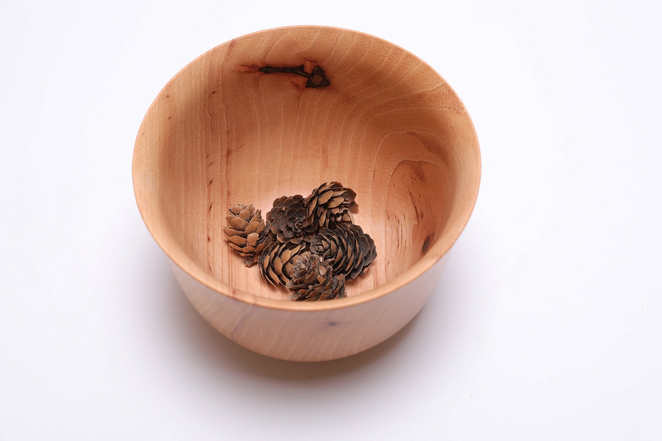  Pecan Liberty Bell bowl with small pinecones for scale, handcrafted in NC by Sanders Woodworking
