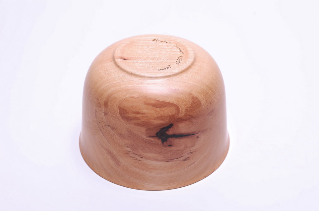 Bottom view of pecan wood bowl showing raised foot and food-safe oil finish
