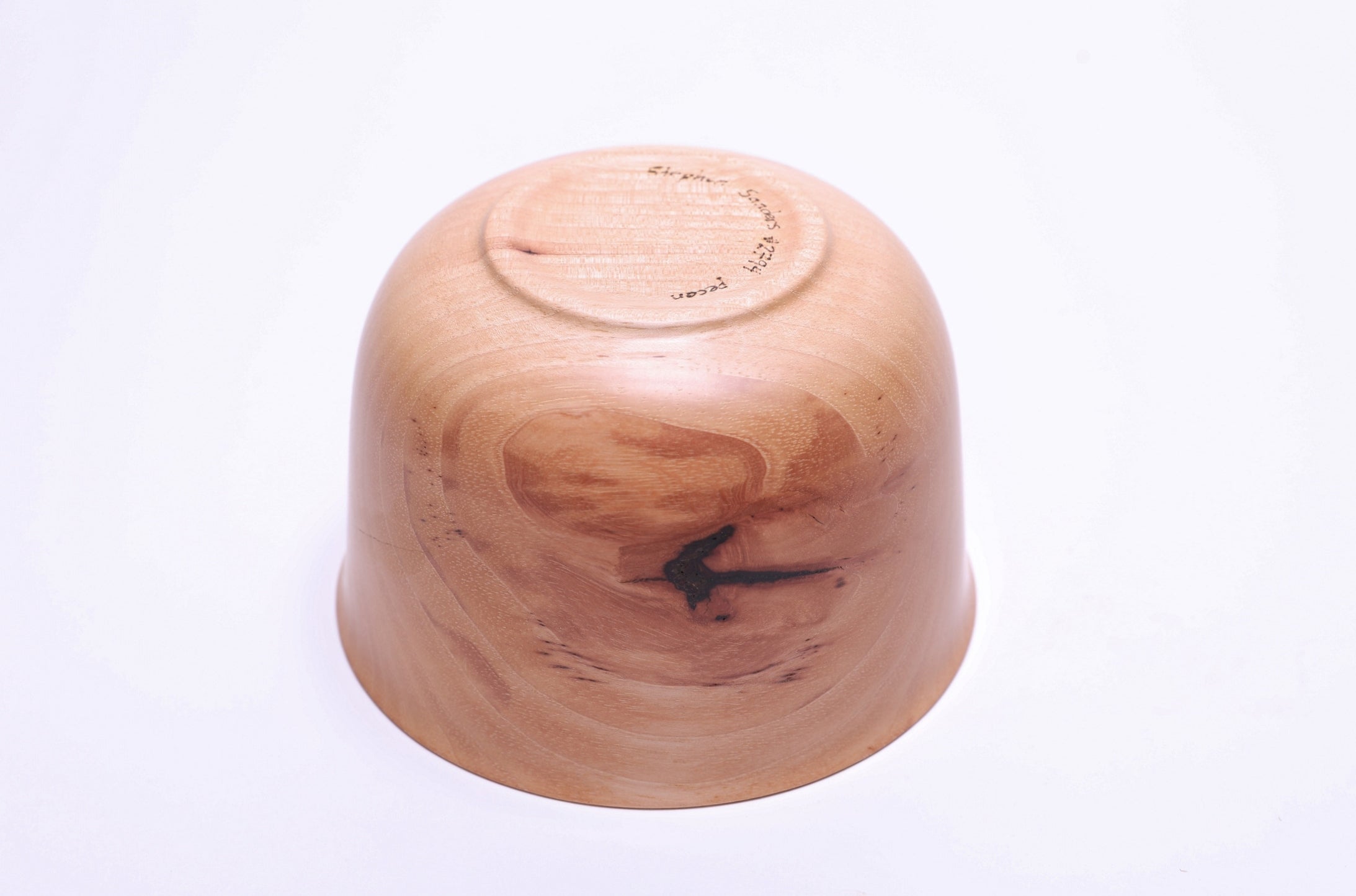 Bottom view of pecan wood bowl showing raised foot and food-safe oil finish