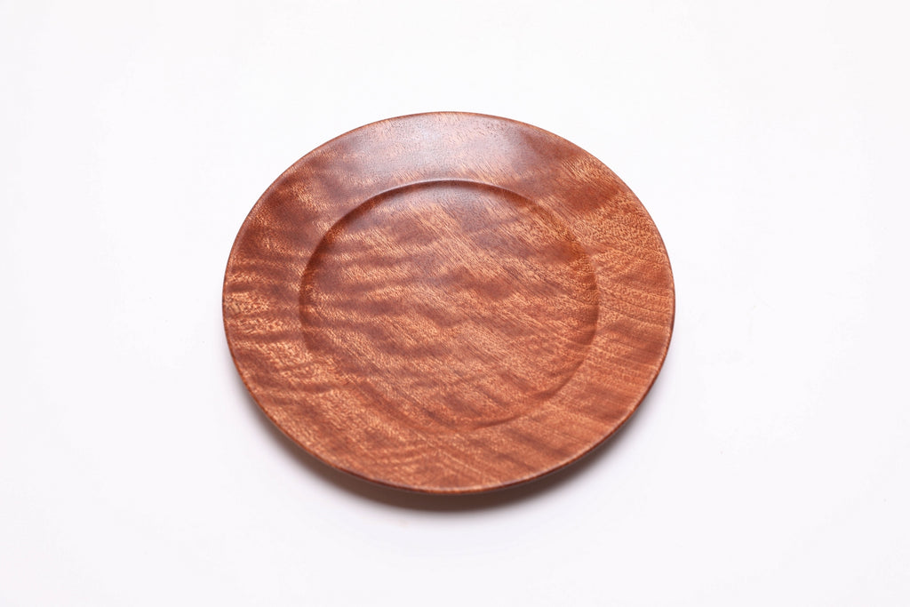 Handcrafted sapele ring dish, top view rotated 30°, highlighting ribbon figure and warm wood tones