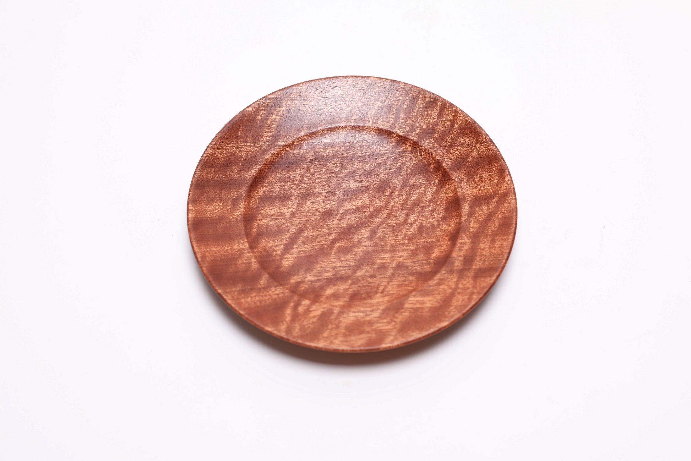 Sapele ring dish top view rotated 30°, pommele figure with cinnamon-hued grain, made in NC