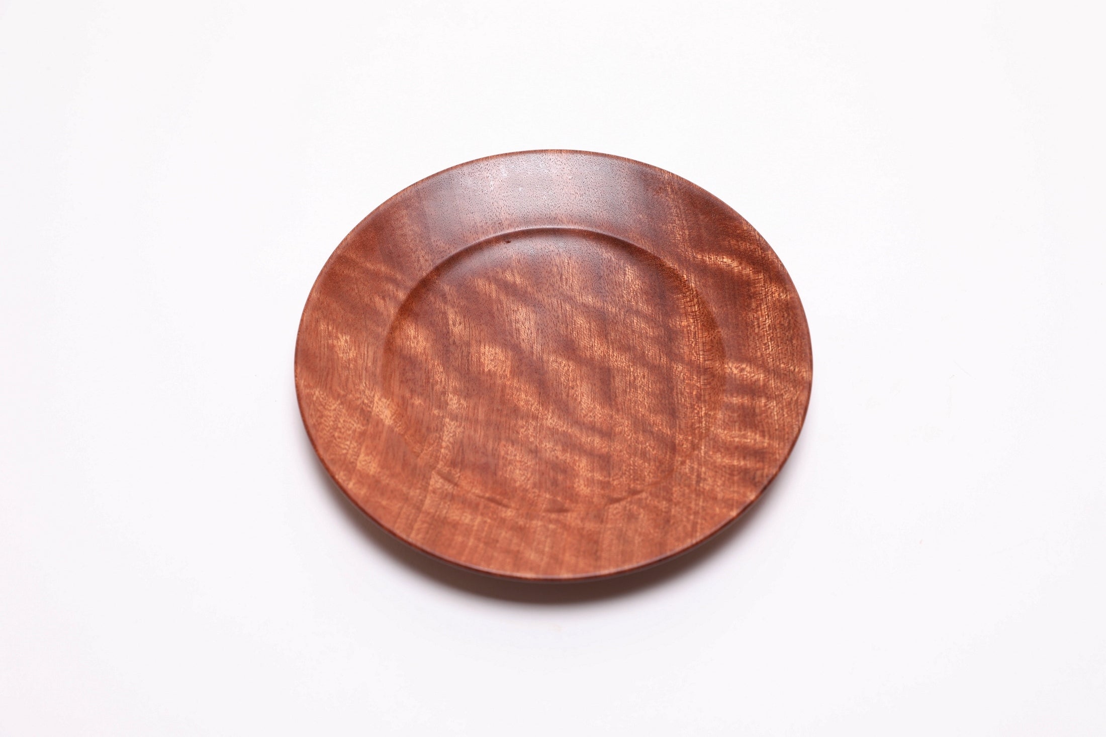 Wooden ring dish top view rotated 30°, quilted ribbon sapele, handcrafted in USA