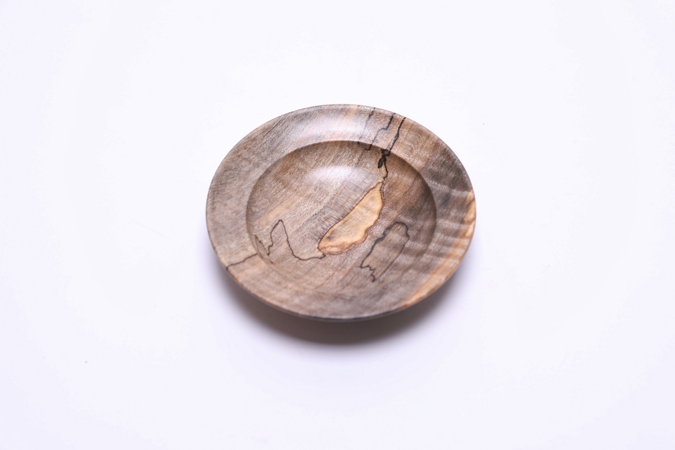 Spalted tiger maple ring dish, top view rotated 135°, amber and gray tones, food-safe oil finish