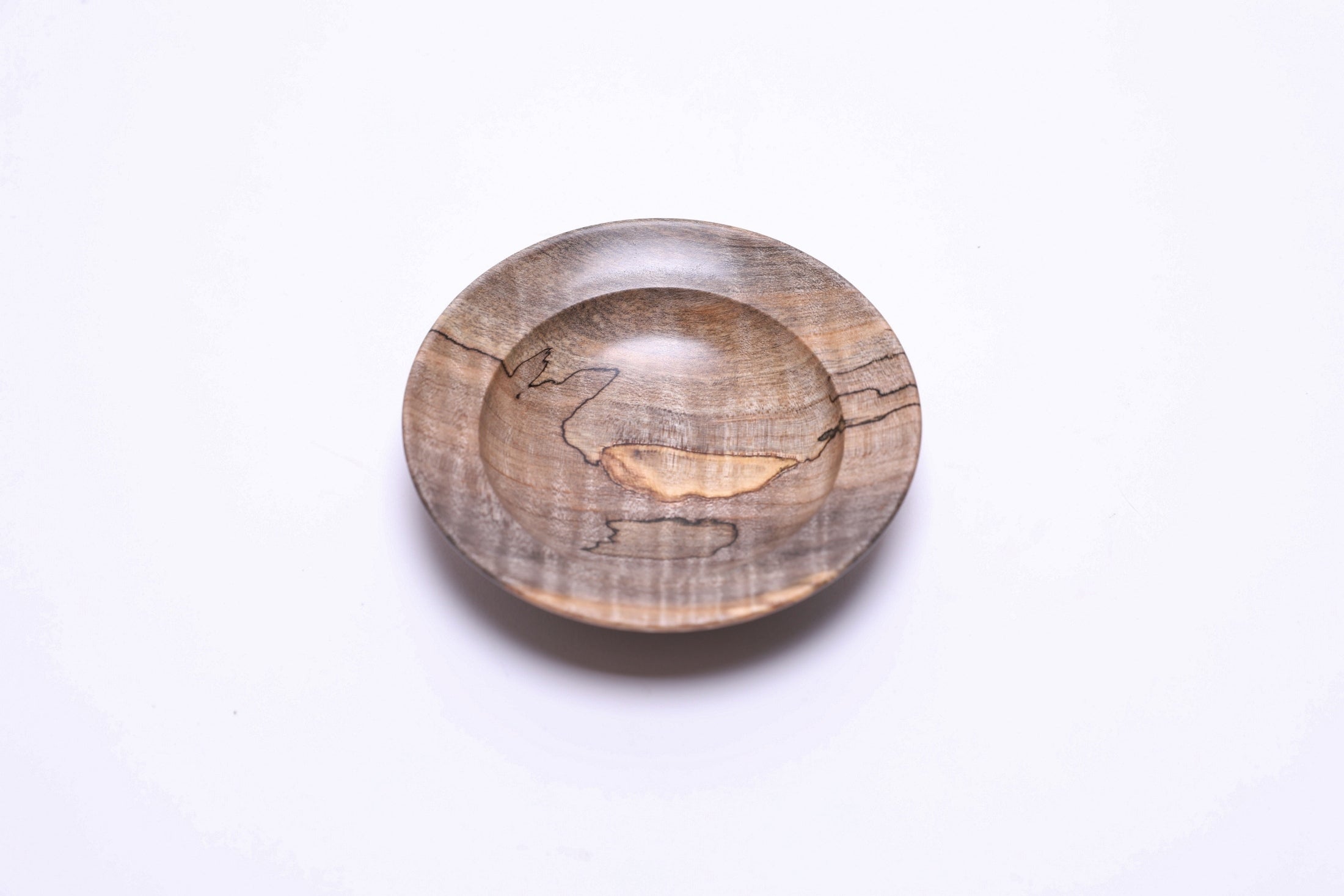 Spalted tiger maple ring dish, top view rotated 225°, warm amber and gray spalting pattern