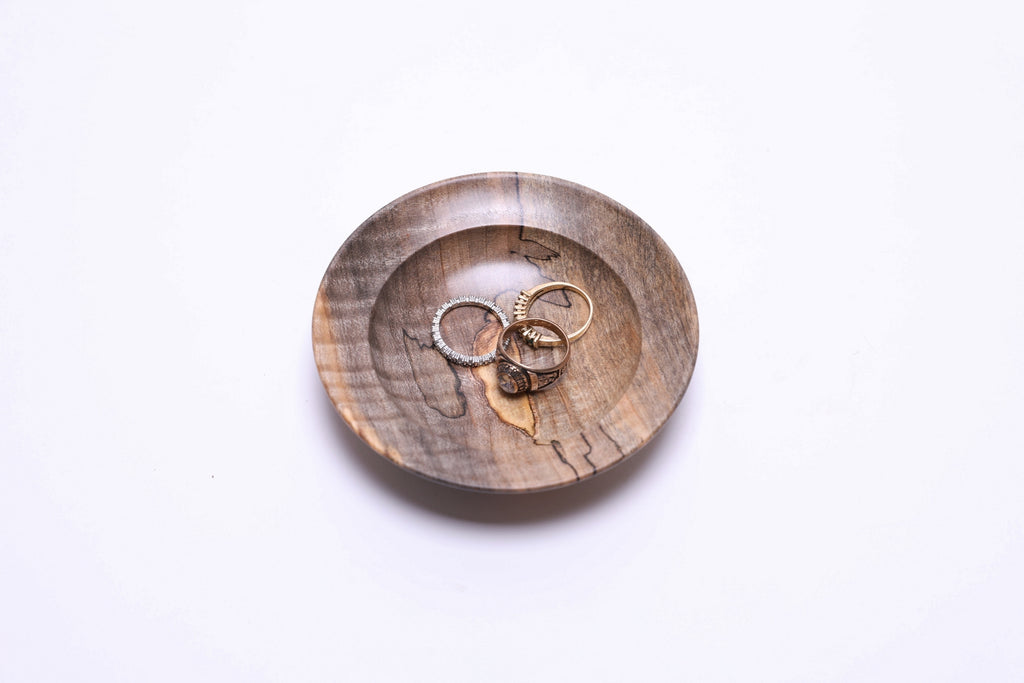 Top view of spalted tiger maple ring dish with three rings for scale, 4⅛" diameter
