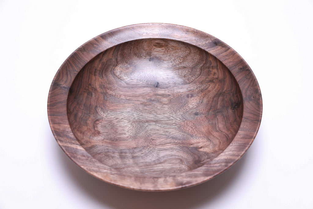 Handcrafted curly wild black walnut wooden bowl top view — rich chocolate brown and copper tones with dramatic curly figure, bud scars with halos, and food-safe oil finish, made in NC by Sanders Woodworking
