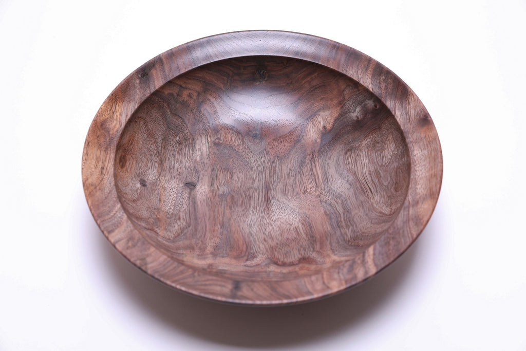 Curly wild black walnut wooden bowl top view rotated 270 degrees — natural oil finish enhancing curly grain depth, warm tan and gray tones with scattered bud scars