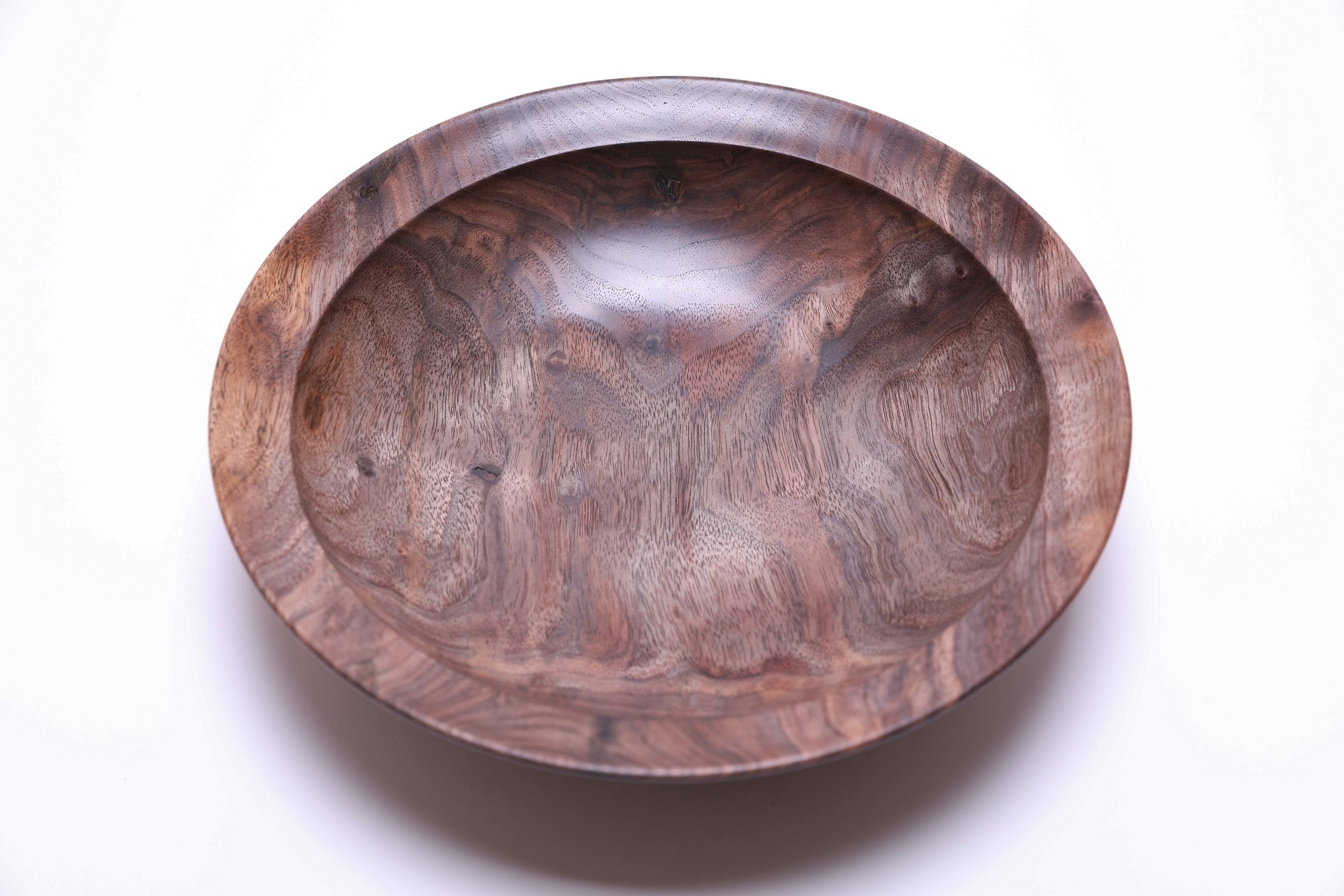 Curly wild black walnut wooden bowl top view rotated 270 degrees — natural oil finish enhancing curly grain depth, warm tan and gray tones with scattered bud scars