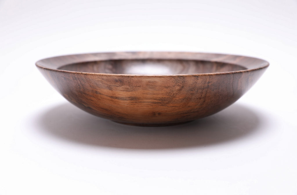 Curly wild black walnut wooden bowl side view rotated 270 degrees — handmade artisan bowl showing full silhouette, undercut rim and curved taper by Sanders Woodworking NC