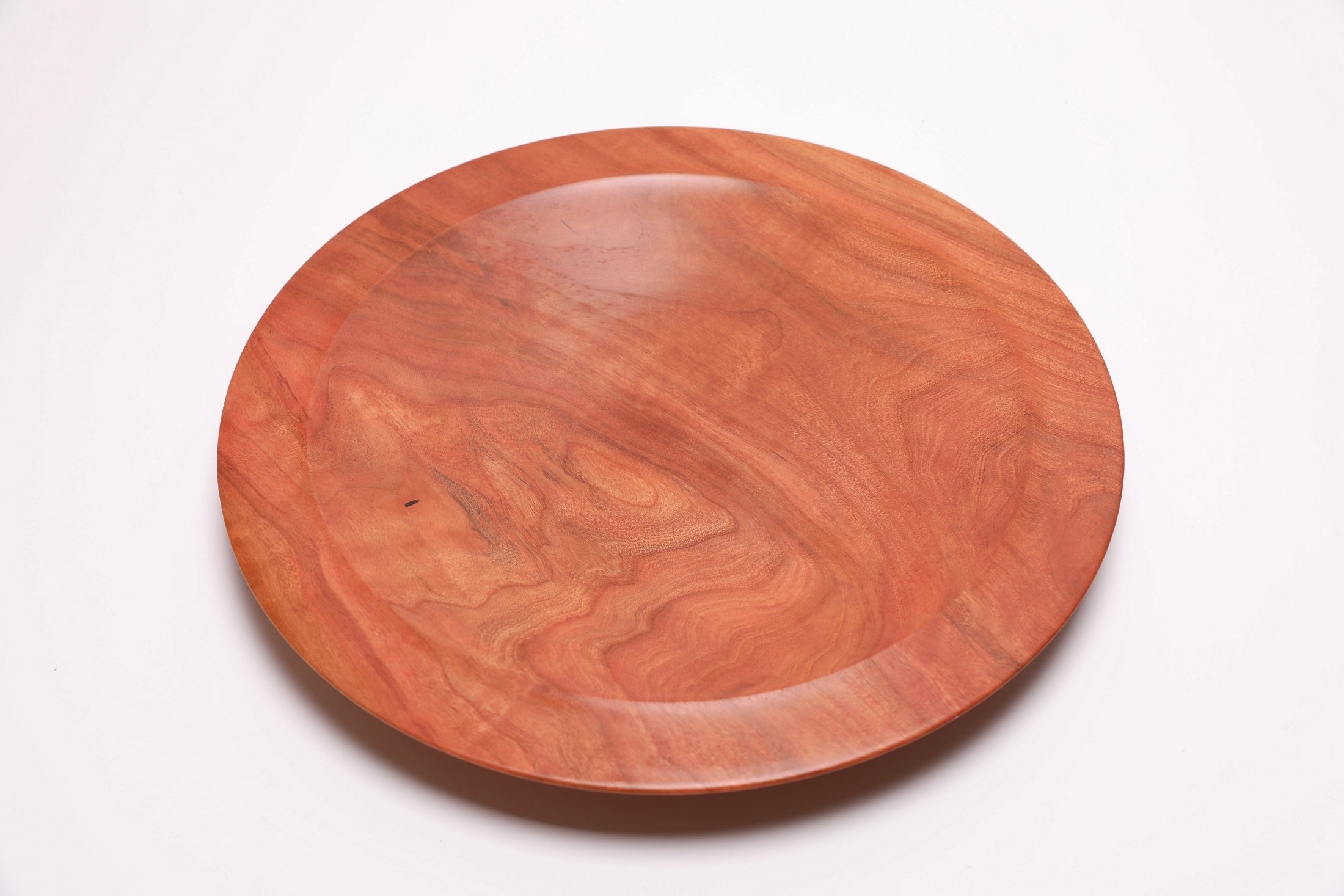 Wild black cherry wooden platter — top view, 60°, showing warm cherry tones and undercut rim profile