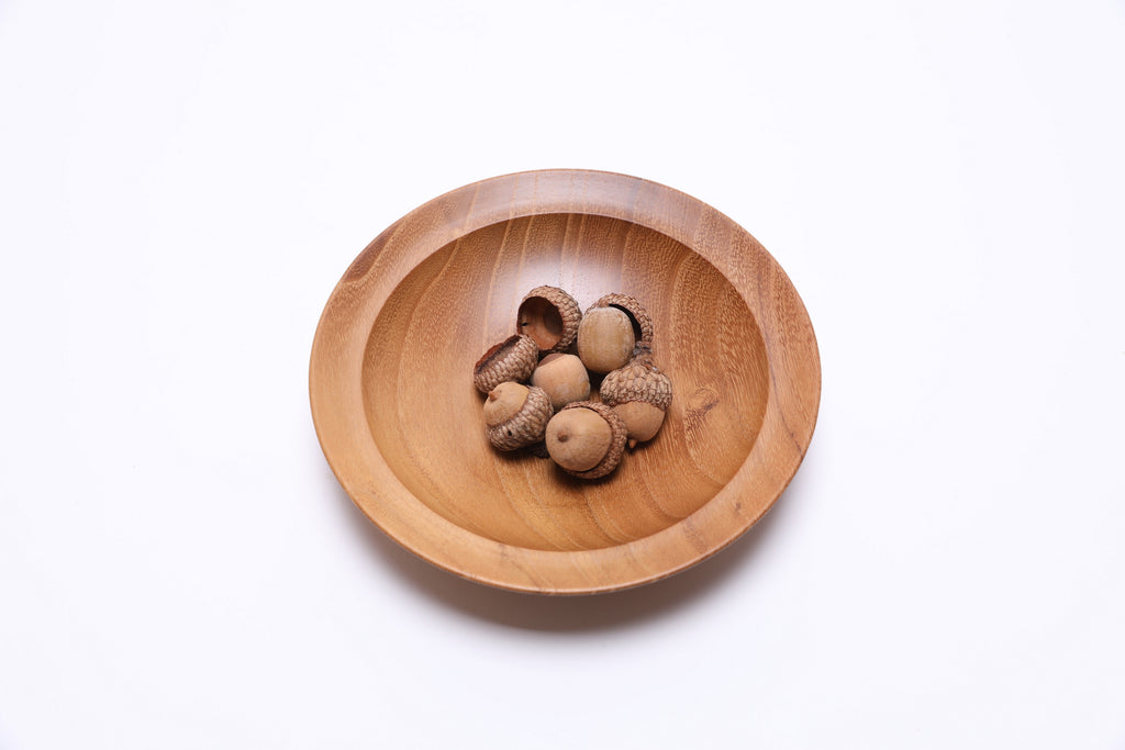 Small black locust wooden bowl top view with acorns for scale, 6 inches wide
