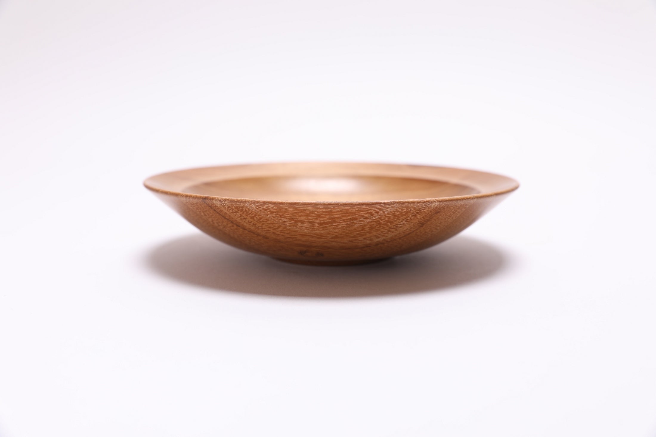 Small black locust wooden bowl side view showing 1-1/4 inch depth, handmade in NC