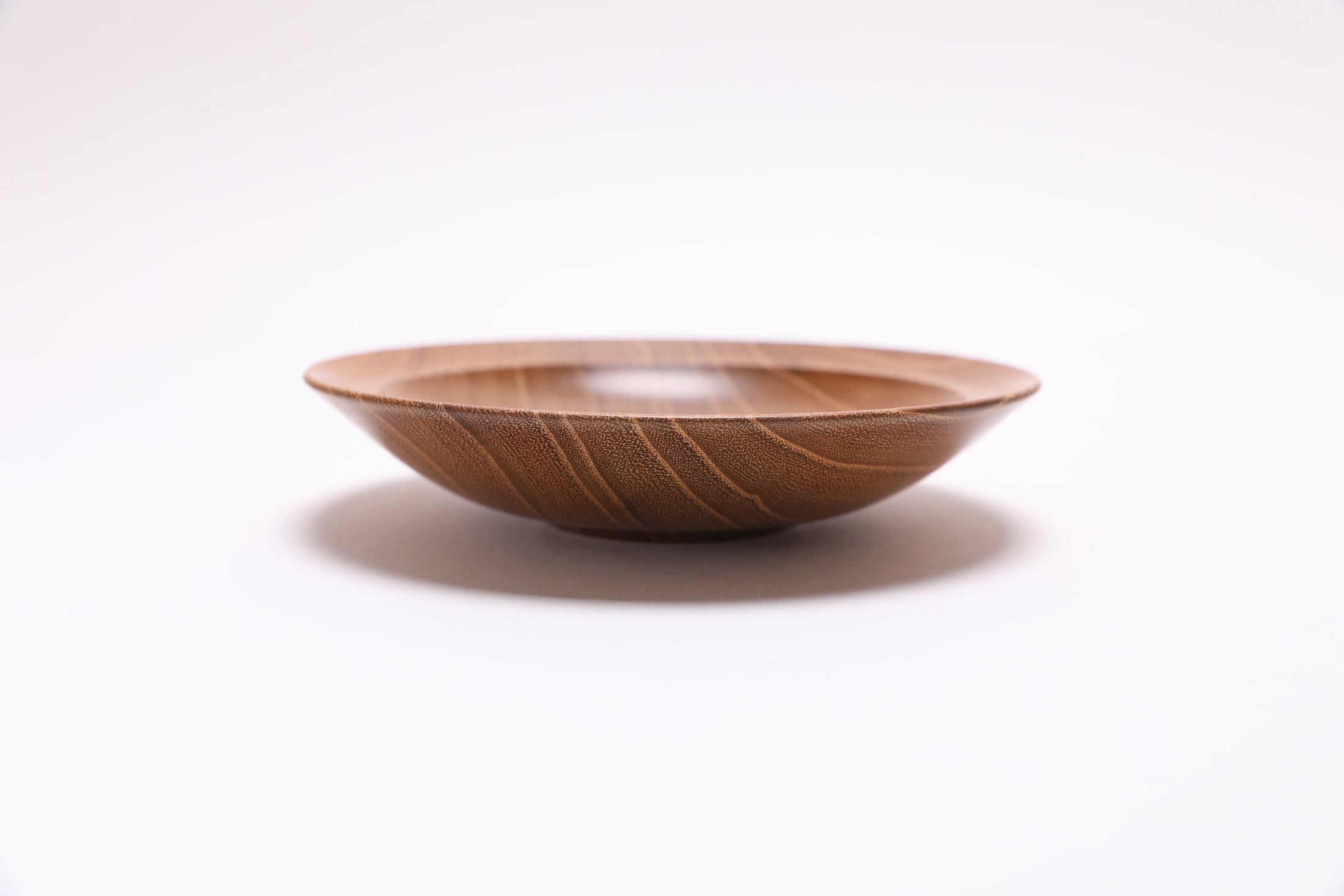 Small black locust wooden bowl side view rotated 90 degrees showing curved rim profile