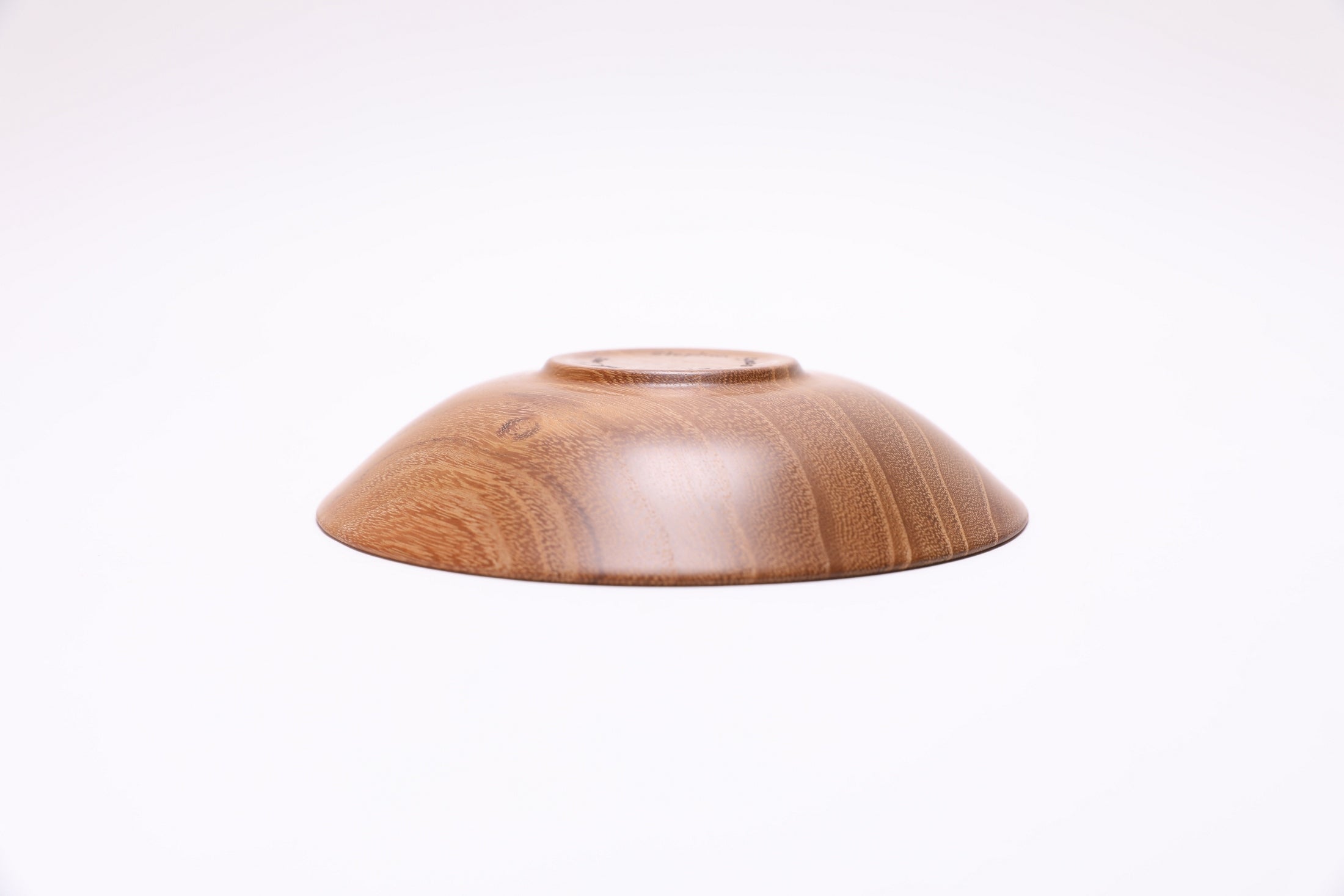 Small black locust wooden bowl bottom view showing foot and natural wood character