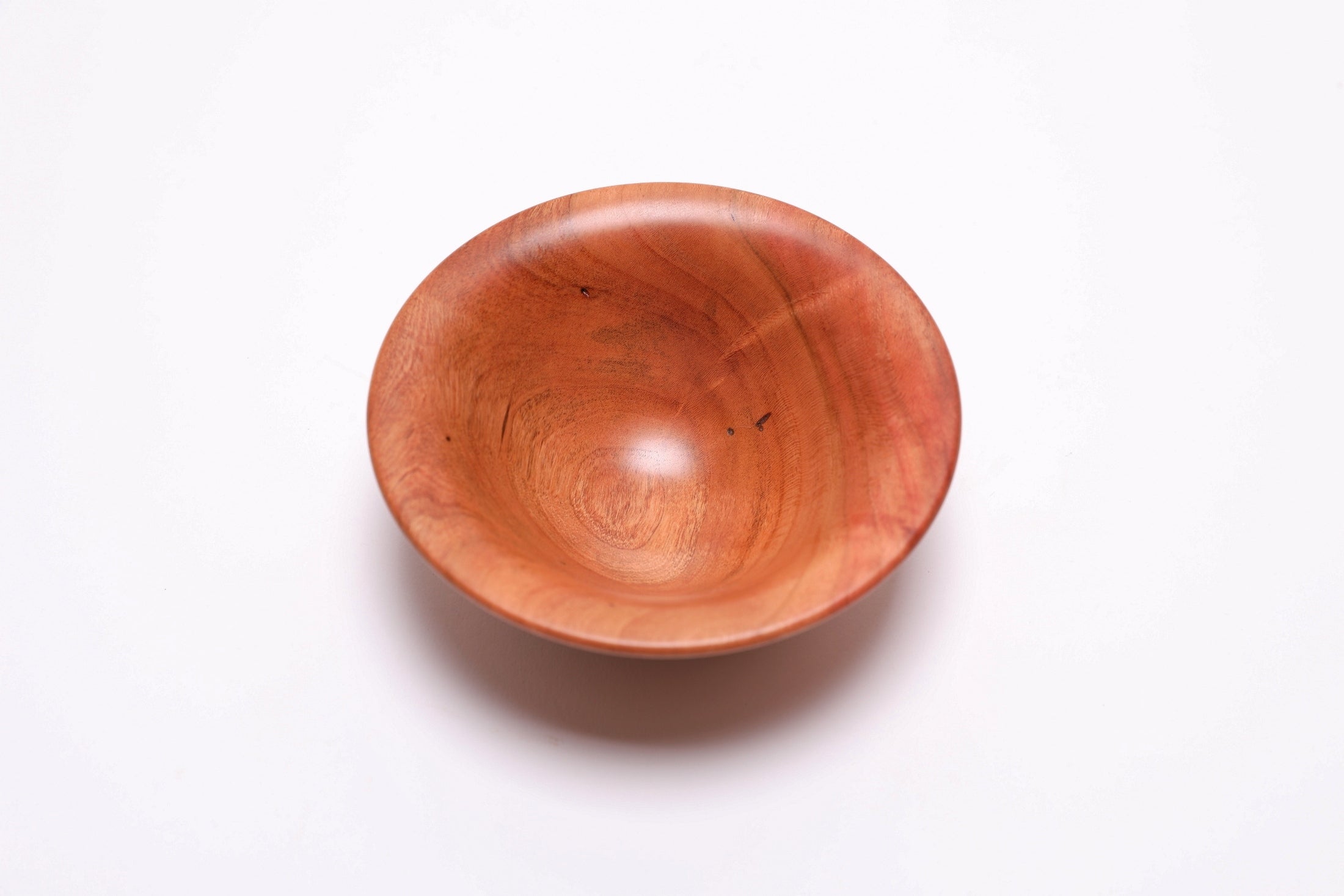 Small wild black cherry wooden bowl top view rotated 90 degrees showing natural wormholes and wood figure