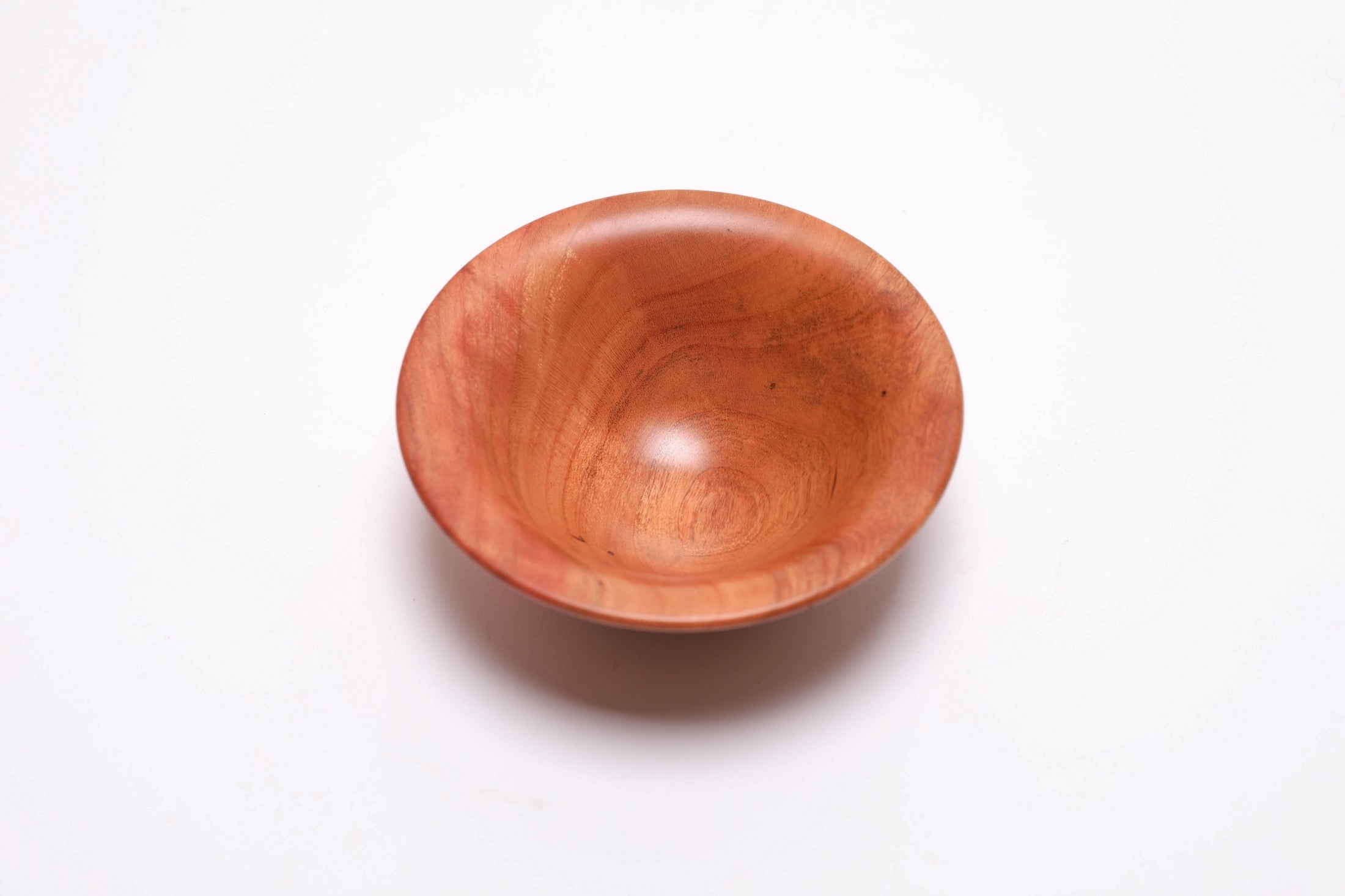 Small wild black cherry wooden bowl top view rotated 270 degrees showing bell shape and rounded rim