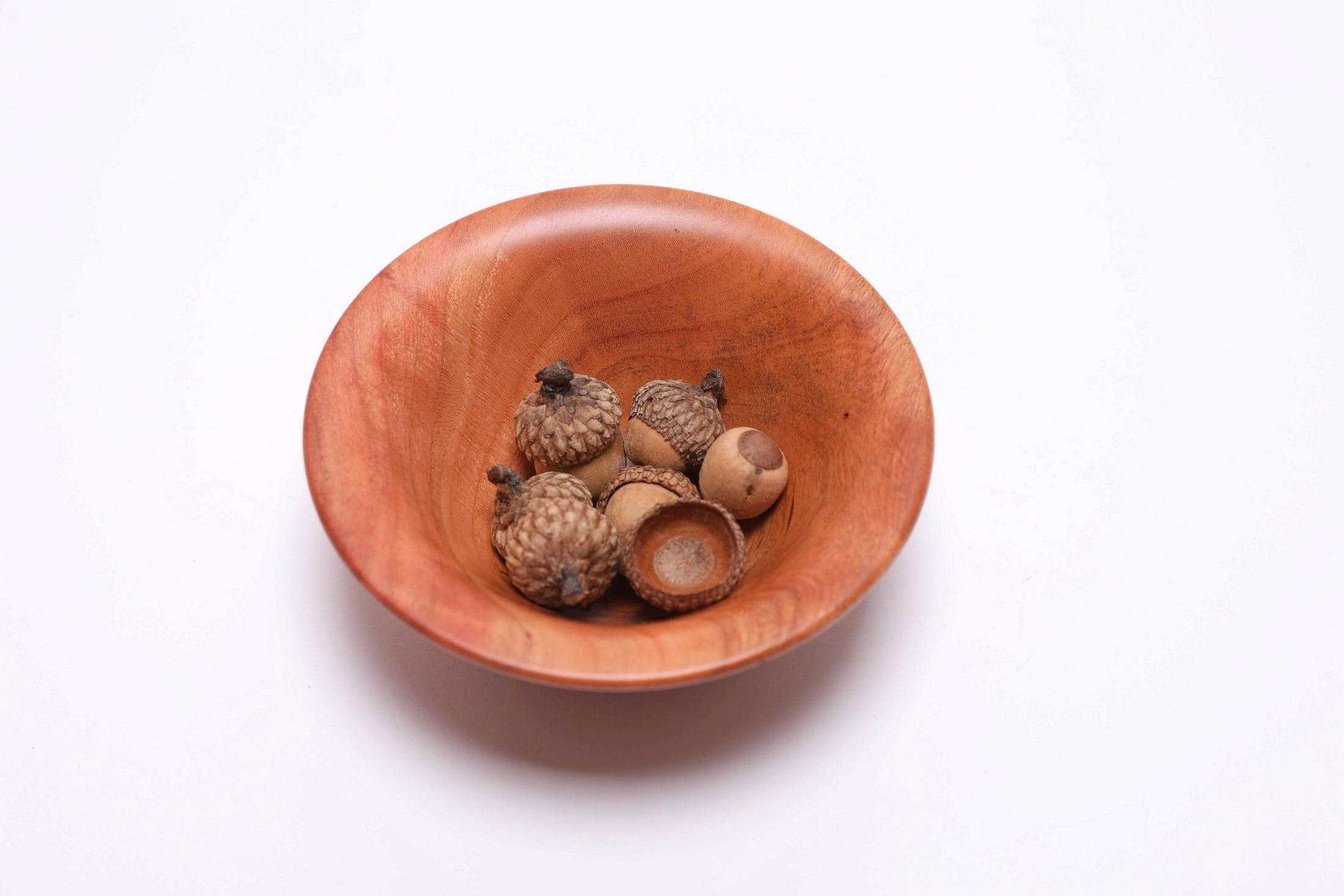 Small wild black cherry wooden bowl top view with acorns for scale, 4 3/4 inches wide