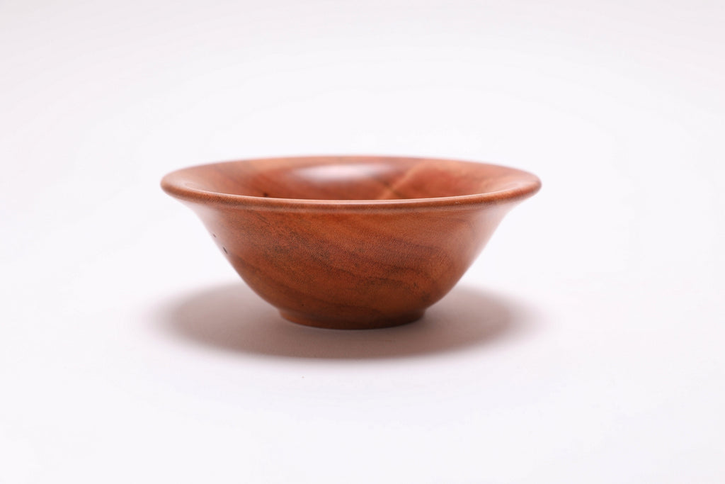 Small wild black cherry wooden bowl side view rotated 90 degrees showing soft rounded rim profile
