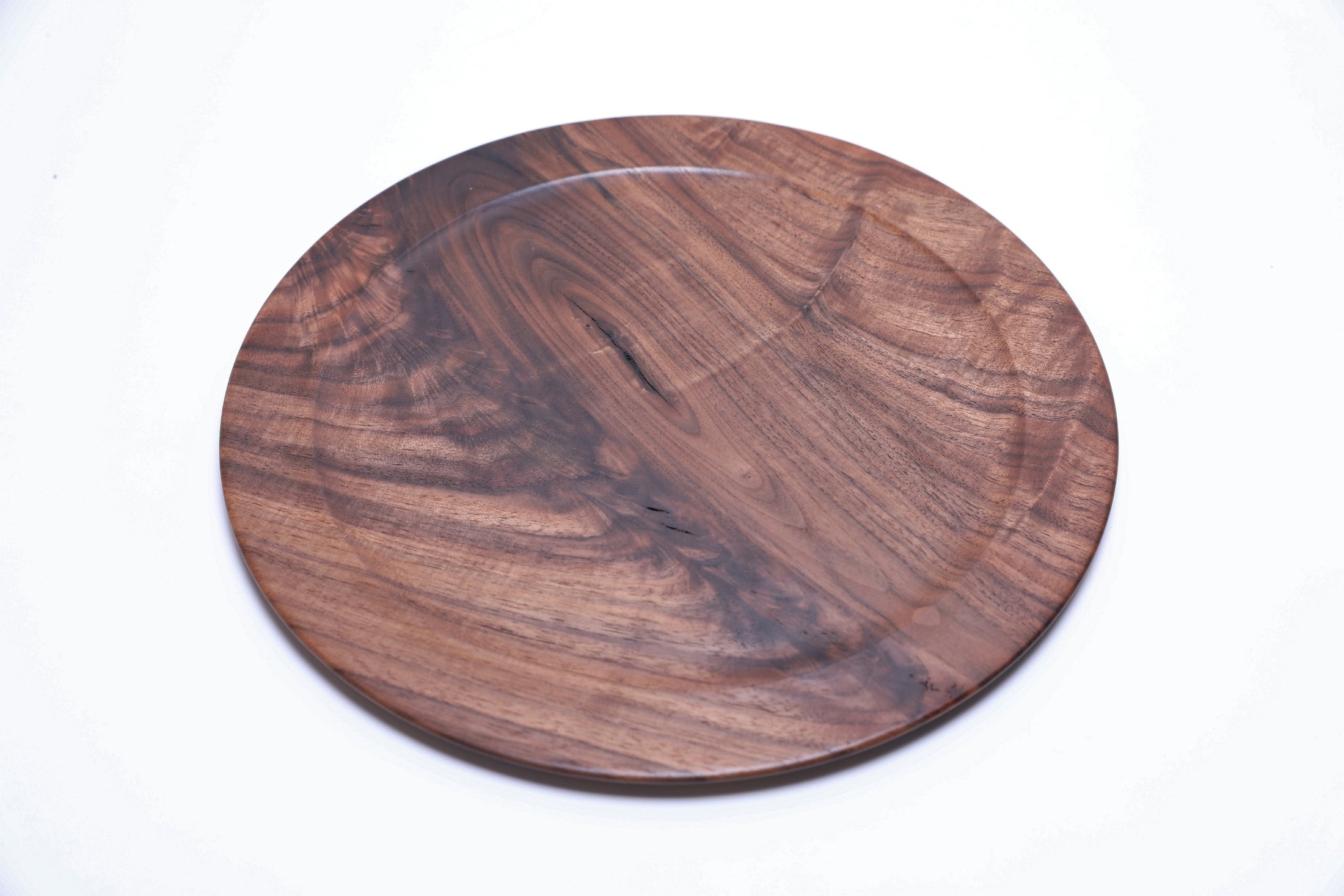 Handmade black walnut crotch burl platter, top view rotated 45°, rich dark grain detail