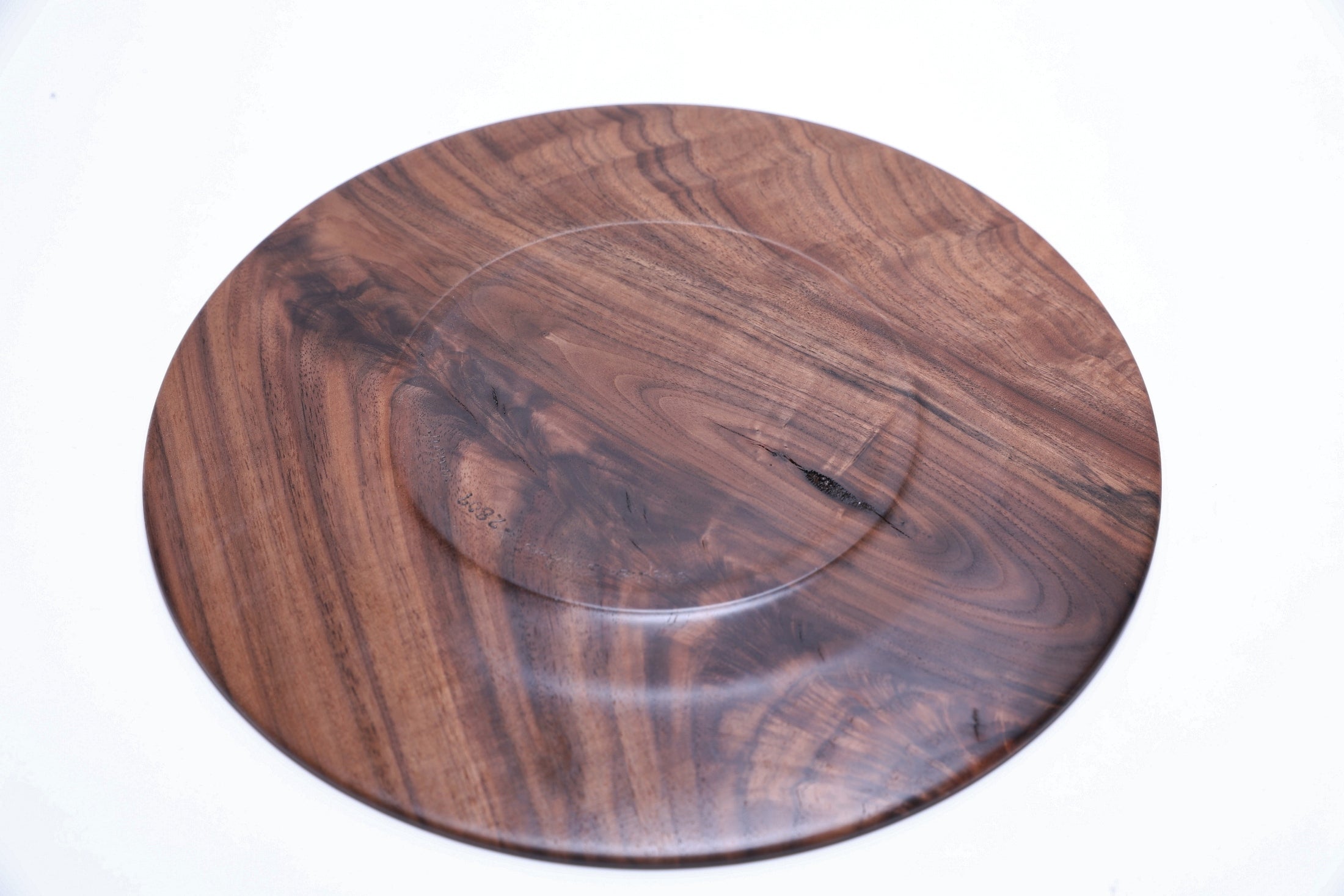 Wild black walnut crotch burl wooden platter, bottom view showing natural finish and craftsmanship