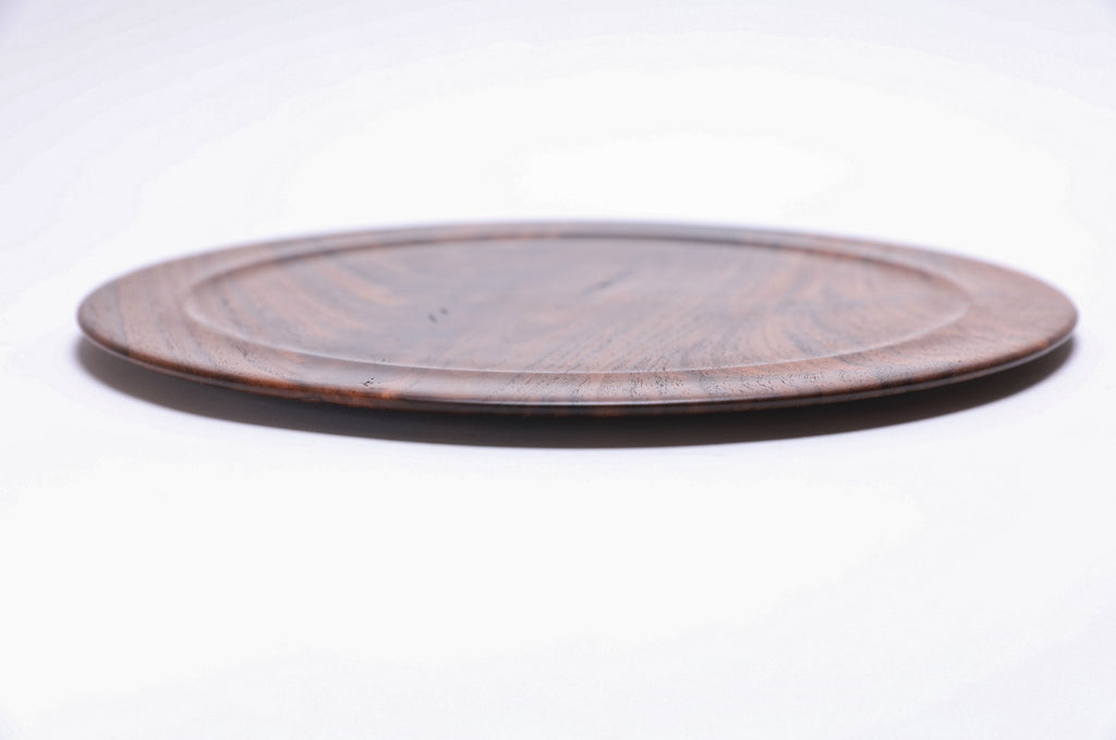Wild black walnut crotch burl wooden platter, side view showing ½" profile and natural finish