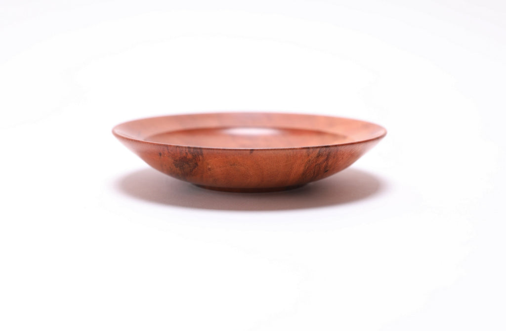 Wild black cherry wooden ring dish, side view at 0°, showing raised foot and curved taper profile
