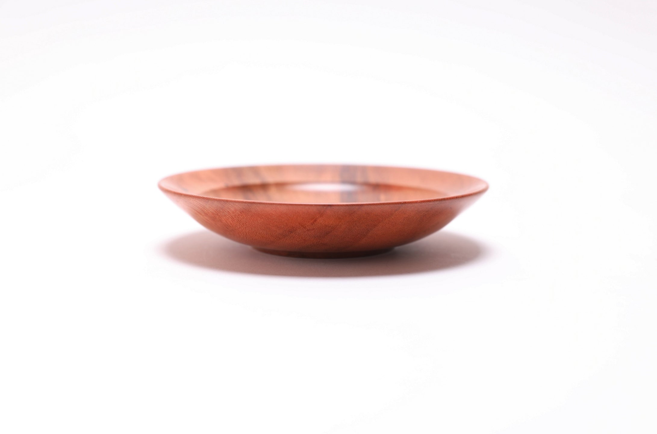 Wild black cherry wooden ring dish, side view at 180°, natural finish and raised foot visible